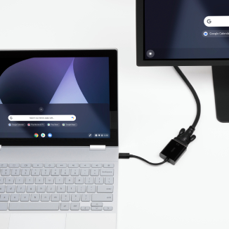 A Chromebook connected to a monitor via an adapter.